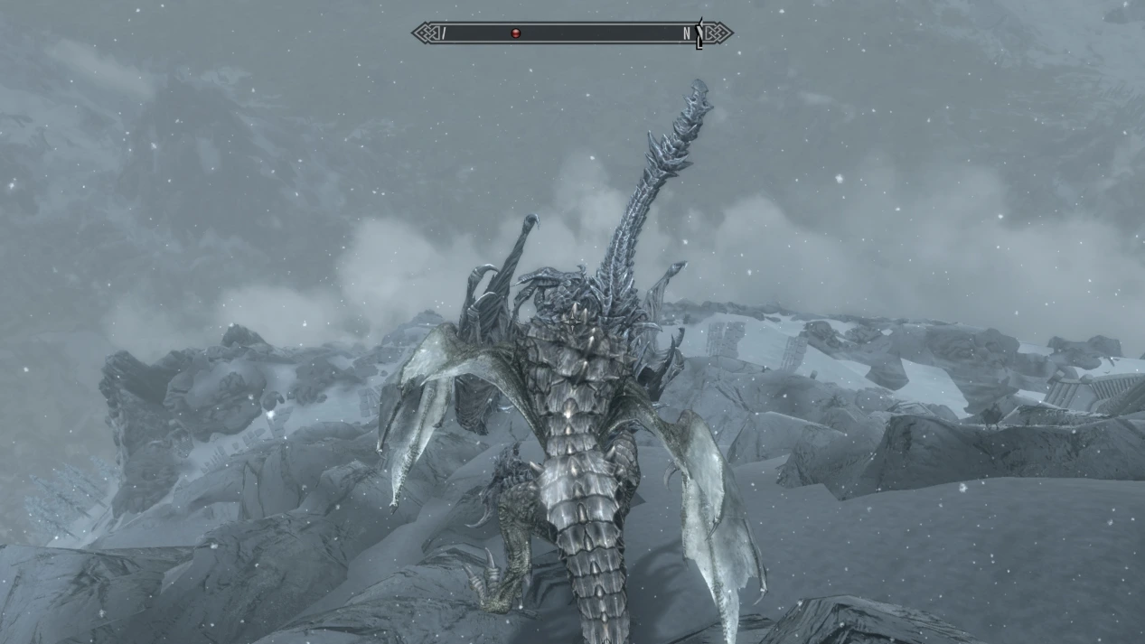 The player - a dragon - pushes the evil dragon, Alduin, down the mountain while he lies gasping for breath 