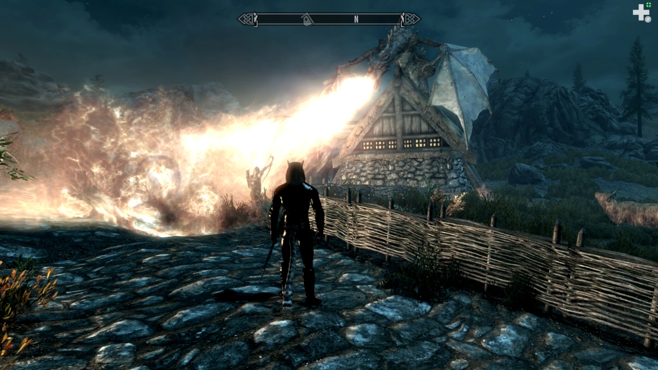 The dragonborn looks on with pride while Nahagliiv the dragon perches on a farmhouse and torches the local guardsmen