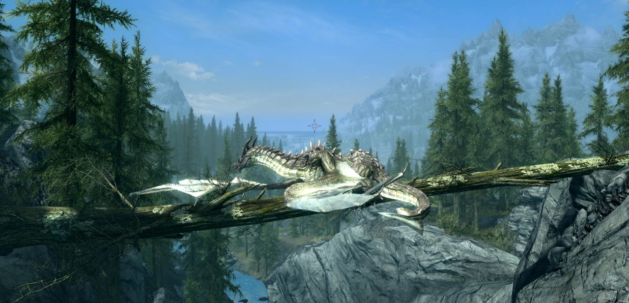 Fahdonmul the dragon rests on a fallen tree that lies over a canyon